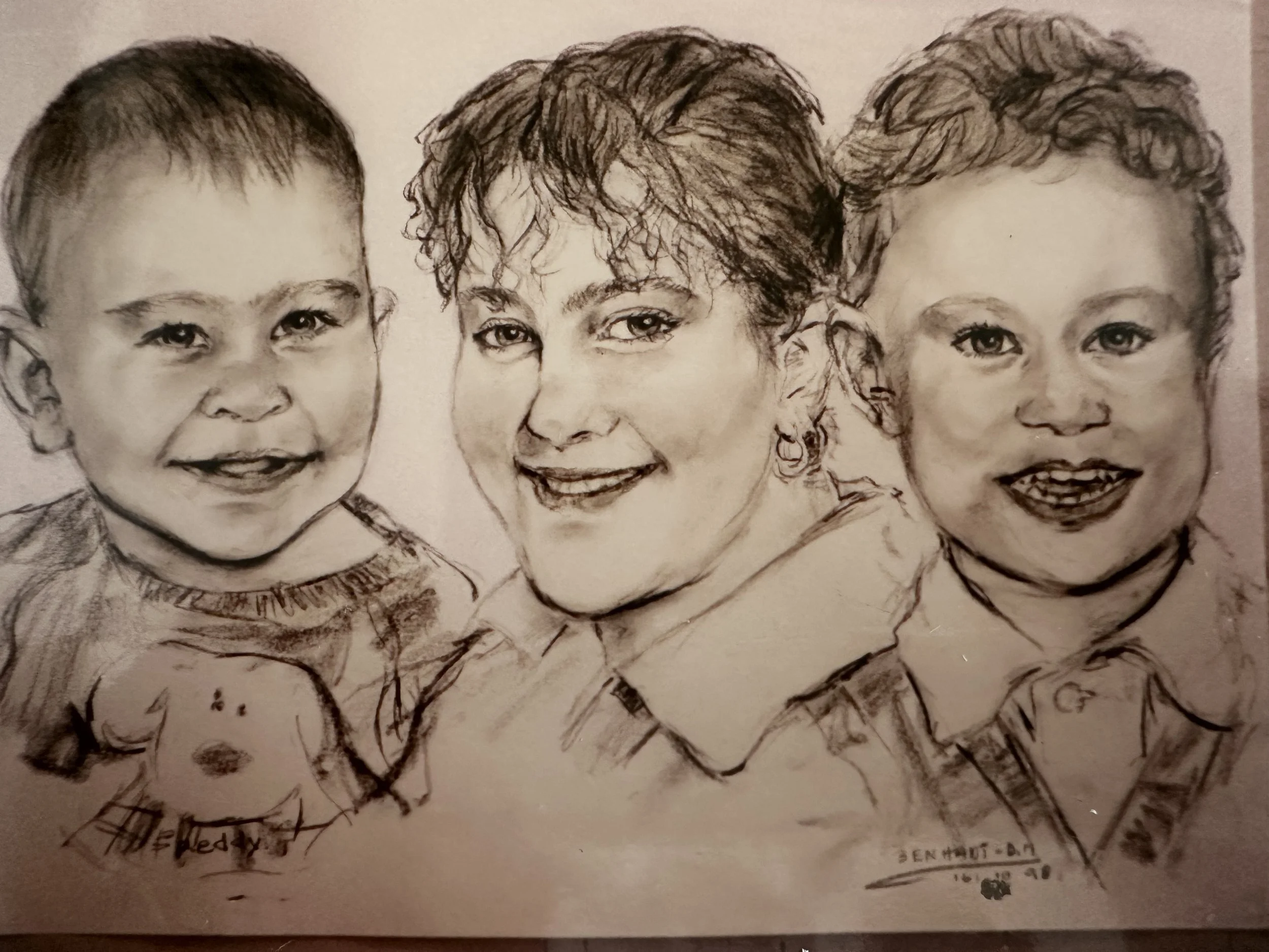 A detailed pencil sketch of three smiling children, showing their faces and upper bodies, with attention to facial expressions and hair.