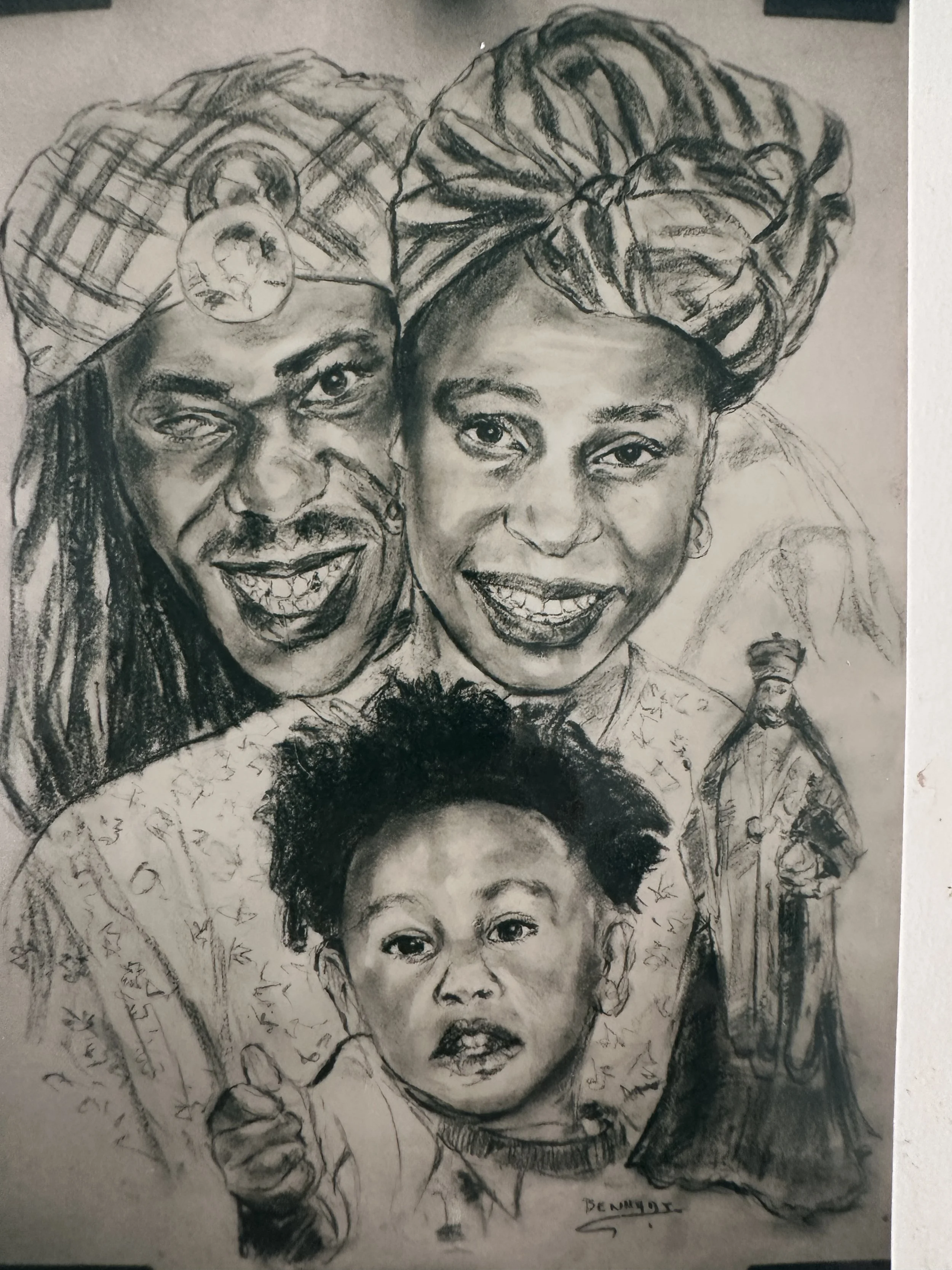 Black and white pencil sketch of joyful family members, including adults and children, all wearing traditional headwraps, smiling and looking at the camera.