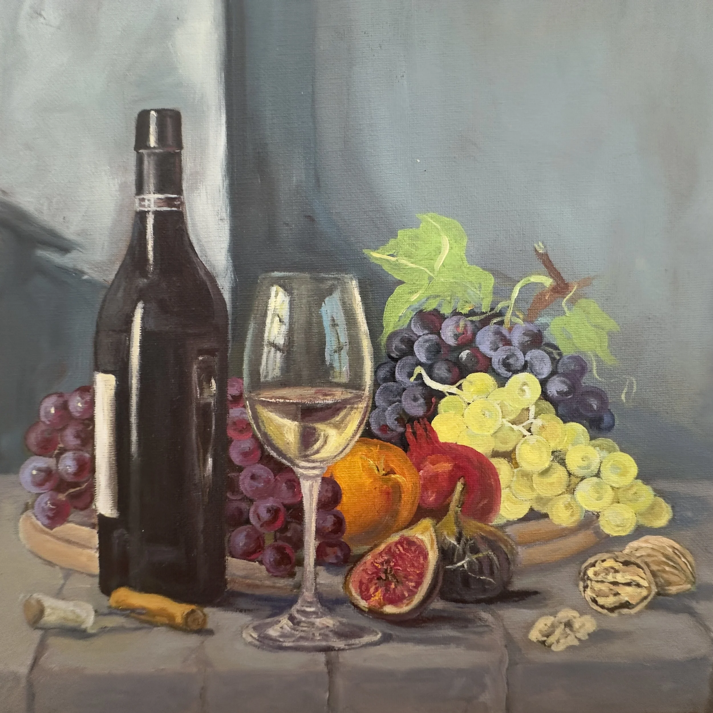 Painting of a still life with a wine bottle, glasses, grapes, and citrus fruits on a table against a gray background.