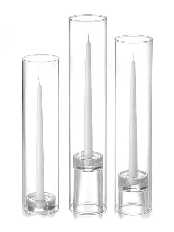 Three tall glass candle holders, each containing a white taper candle