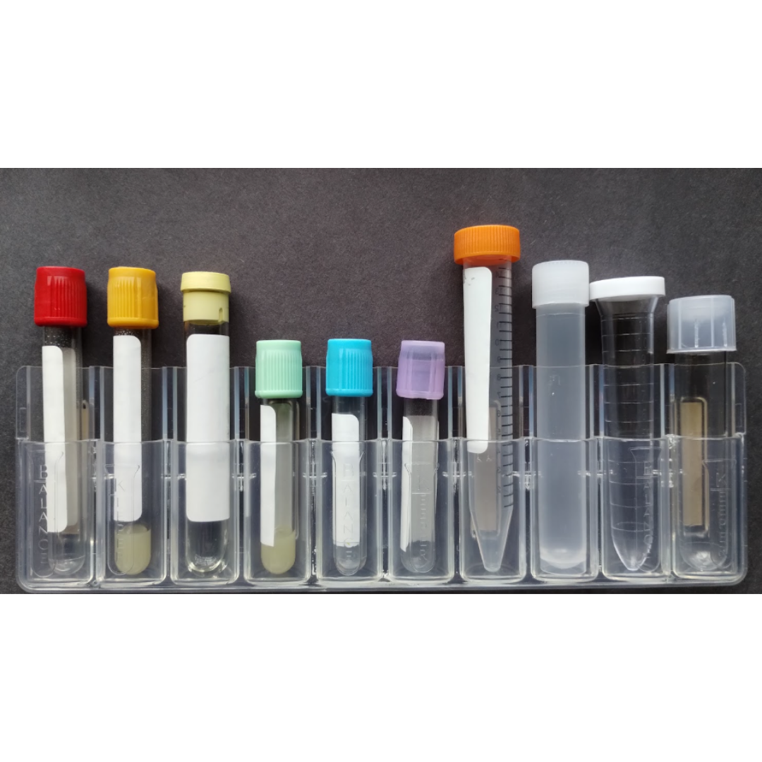 A set of10 collection tubes with colored caps in a clear plastic holder on a dark surface.