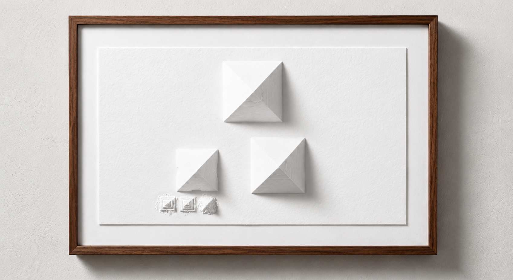 A framed display of three white geometric pyramid-shaped objects of different sizes on a white textured background.