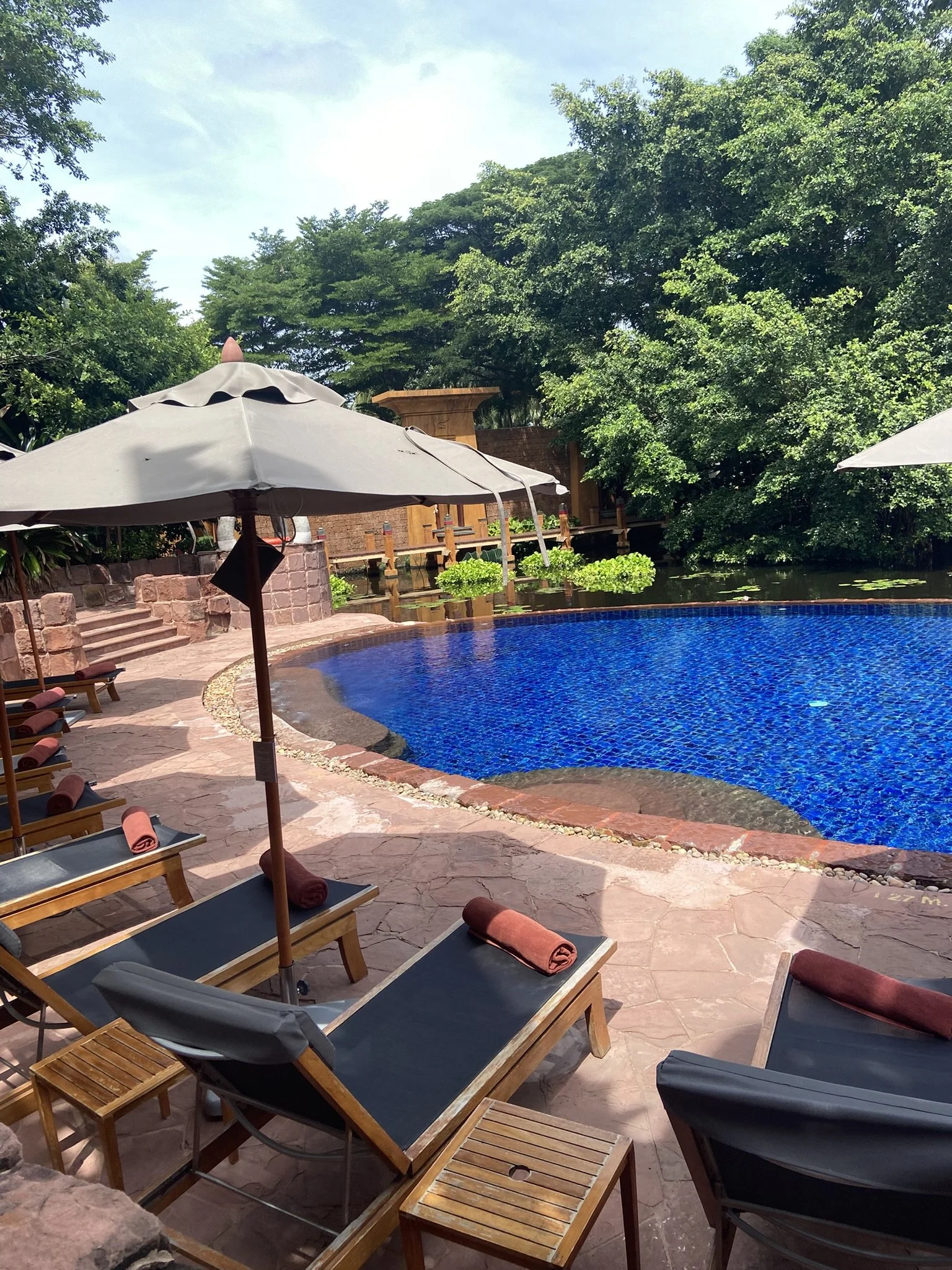 Poolside seating overlooking the swimming pool at Anantara Hua Hin Resort, Thailand.