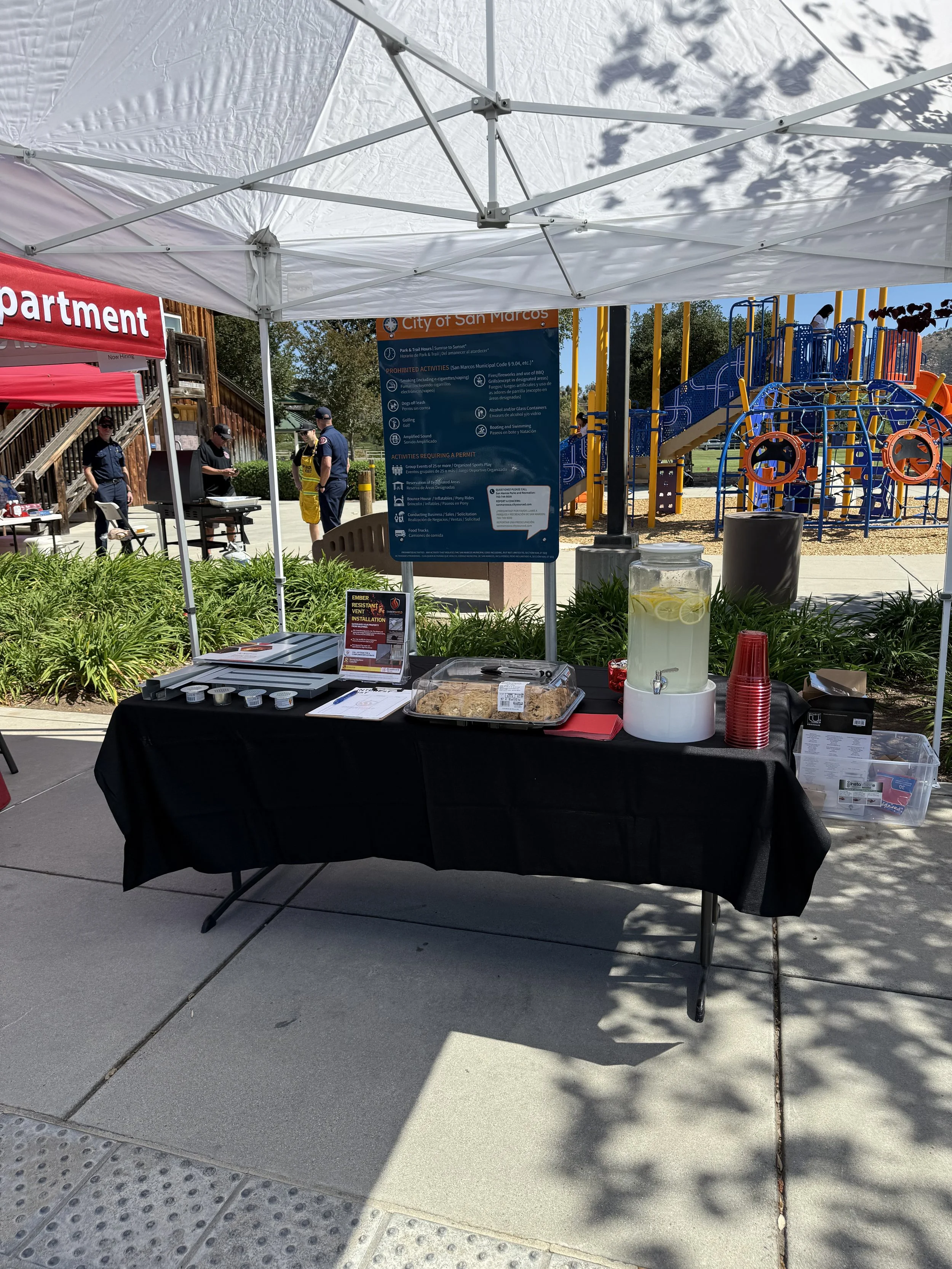 Image of an EmberShield Systems table set up with information and BrandGuard vents at a San Marcos fire safe council event