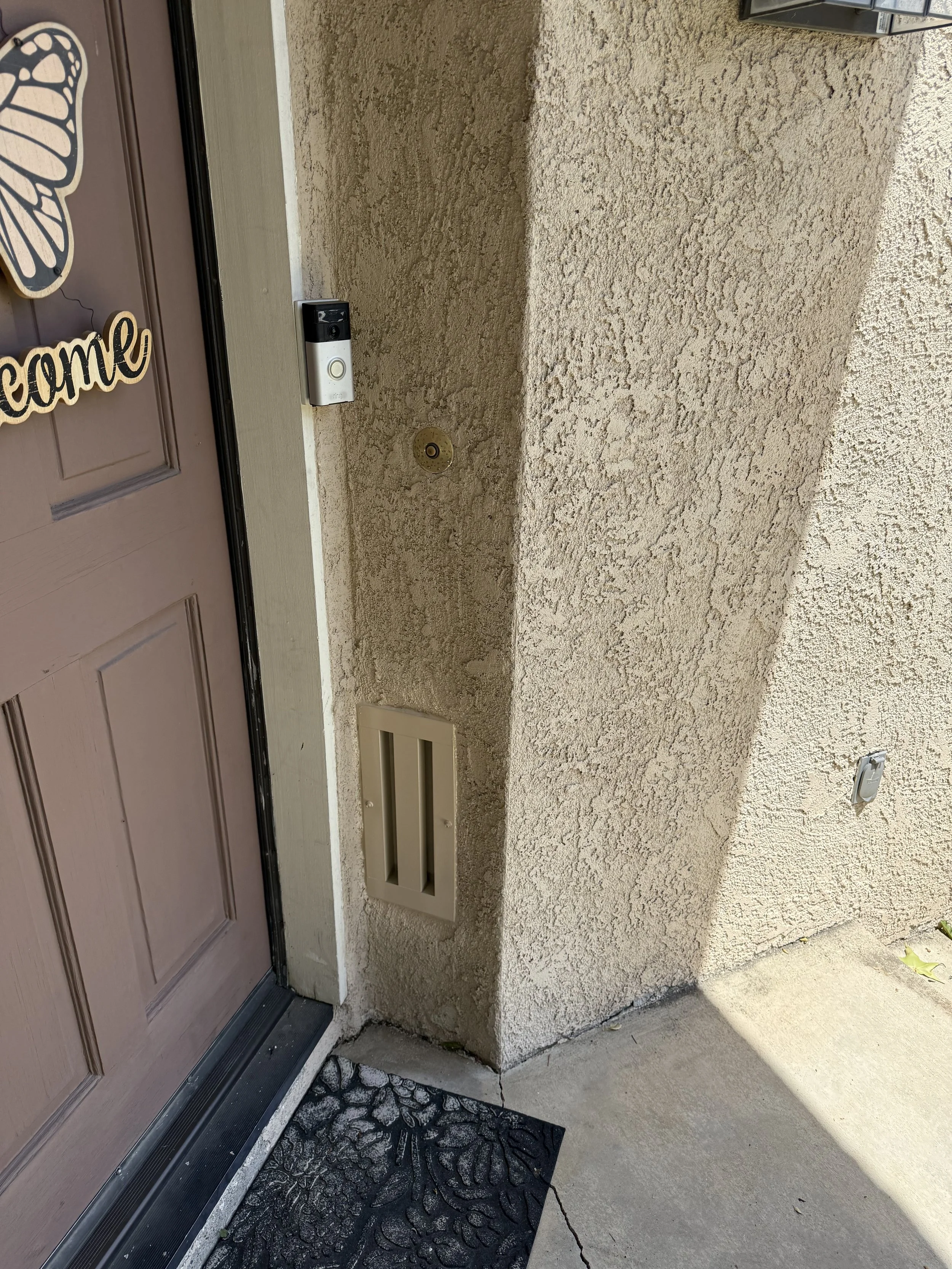 Image of a BrandGuard ember resistant retrofit foundation vent near a front door entry to a home
