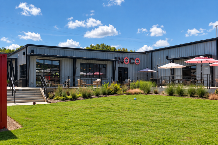 Outdoor patio and lawn at NOCO Brews & Bites in Raleigh