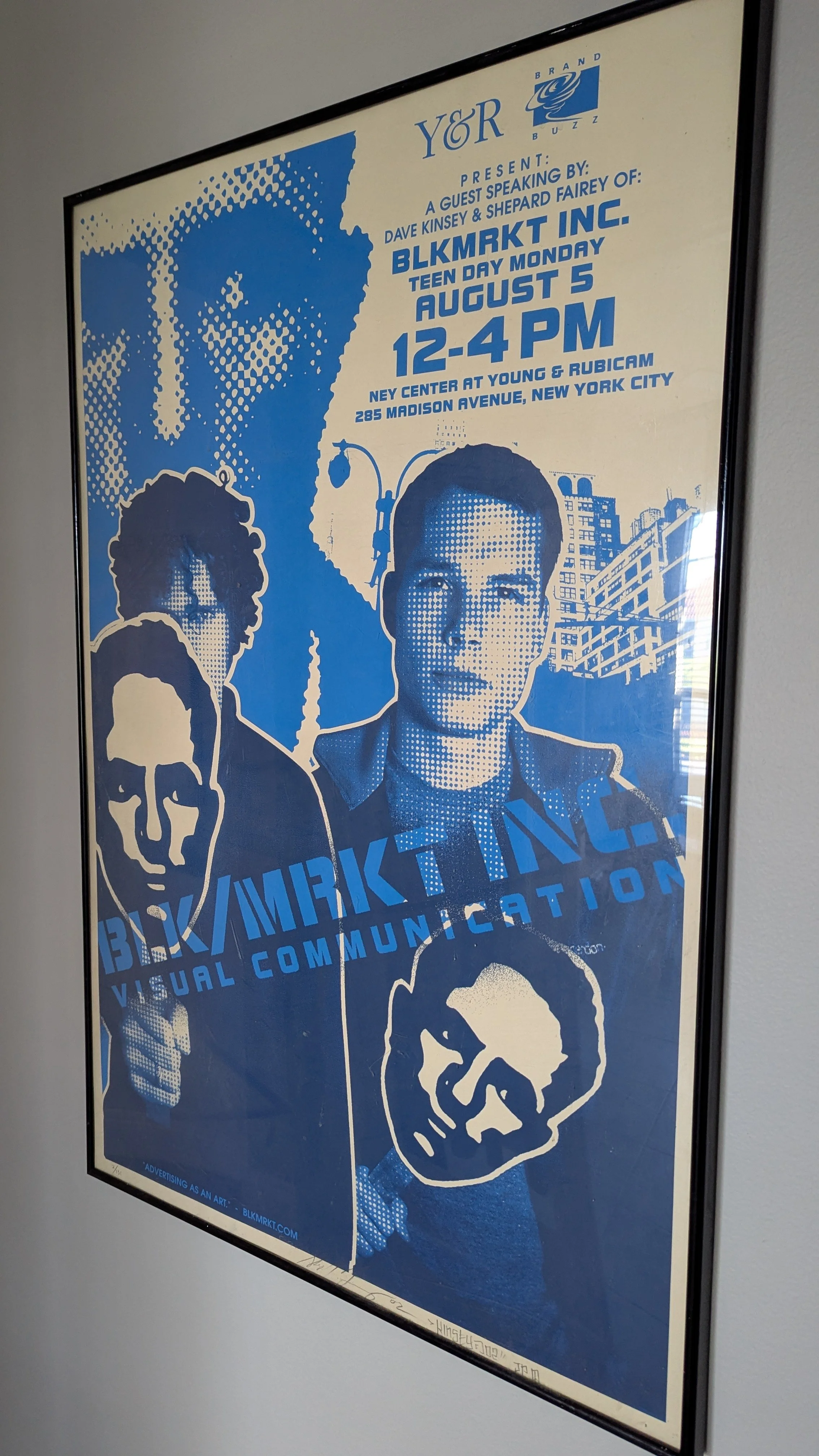 Poster advertising a talk at NY Center by Dave Kinsey & Shepard Fairey, titled 'Black Market Inc.' on August 5, from 12 to 4 PM, featuring stylized portraits of two men with dark sunglasses, and a skull design.