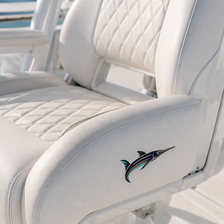 Close-up of white cushioned boat seat with a marlin fish logo on the side.