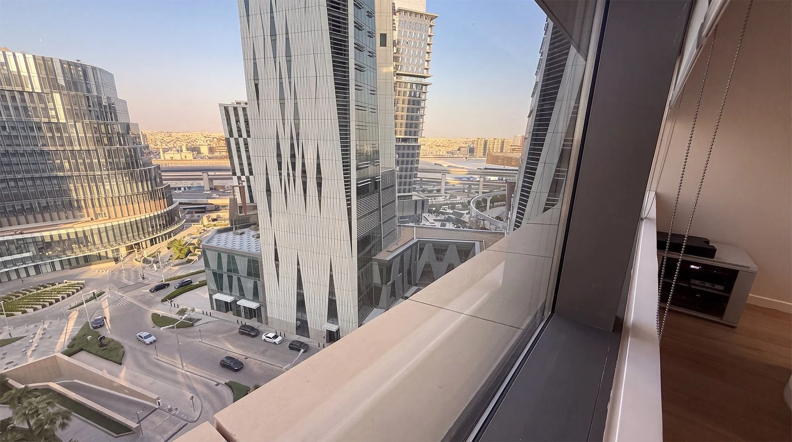 View through a campus window across the towers of King Abdullah Financial District.