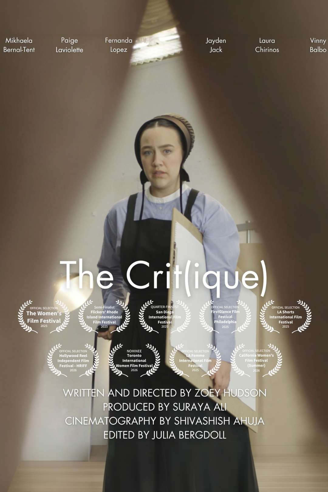 The image shows a young woman standing in a room, seen through a gap formed by two people holding their fingers apart, creating a frame around her. She has dark hair, is wearing a head covering and a dark apron over a light blue shirt, and holds a clipboard. The text on the image includes film festival awards and credits for the film titled 'The Crit(que)'.