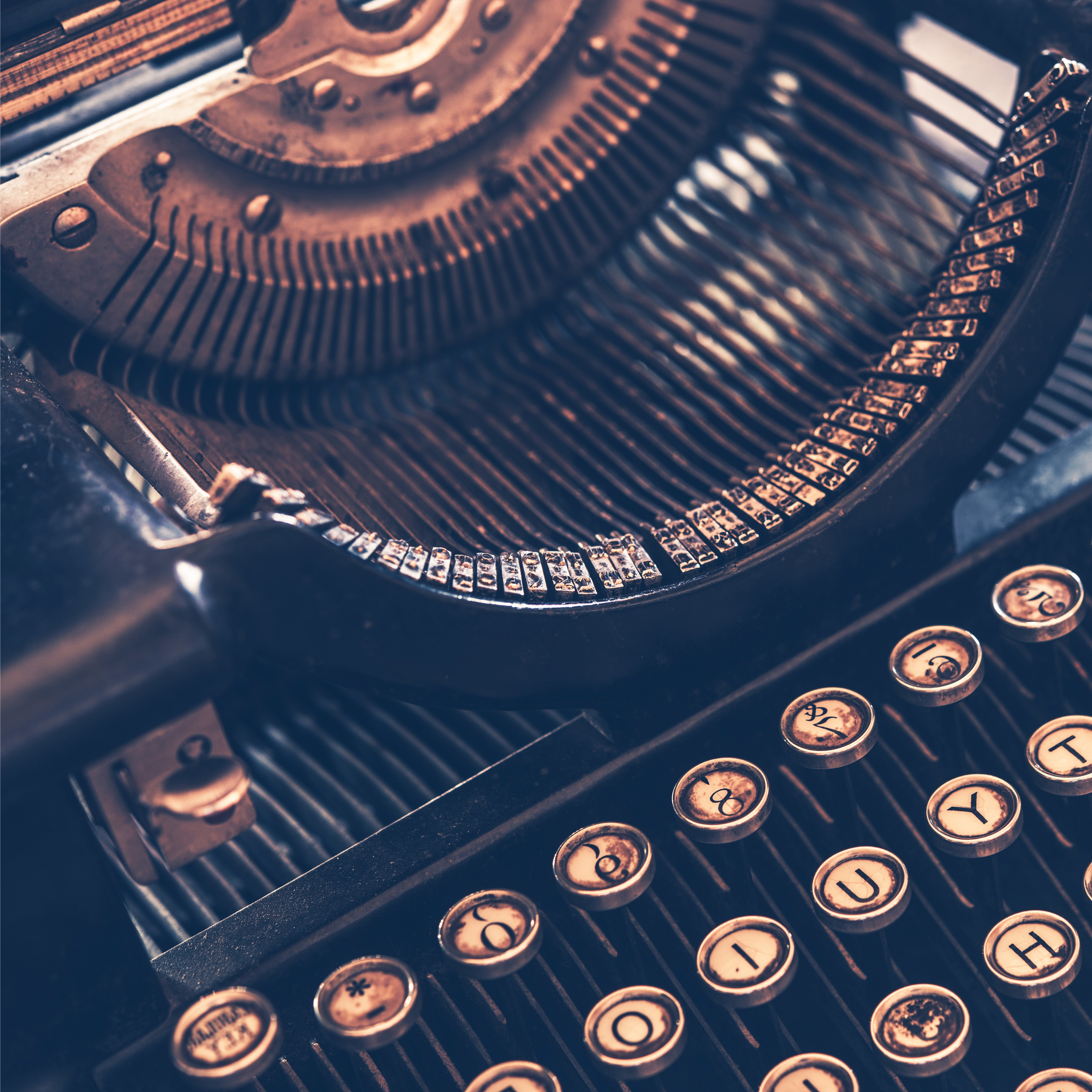 Close-up of a vintage typewriter's keys in warm light.