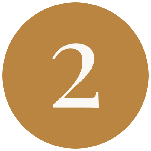 A circular badge with a gold background and a large white number 2 in the center.