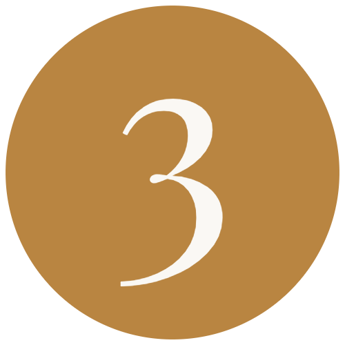 A circular badge with a gold background and a large white number 3 in the center.