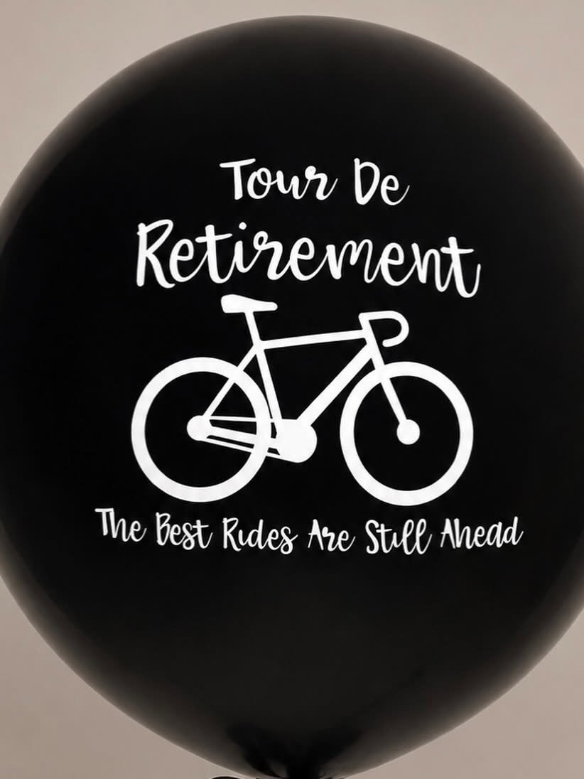 Black retirement balloon featuring a white bicycle graphic and the text “Tour De Retirement” and “The Best Rides Are Still Ahead.”