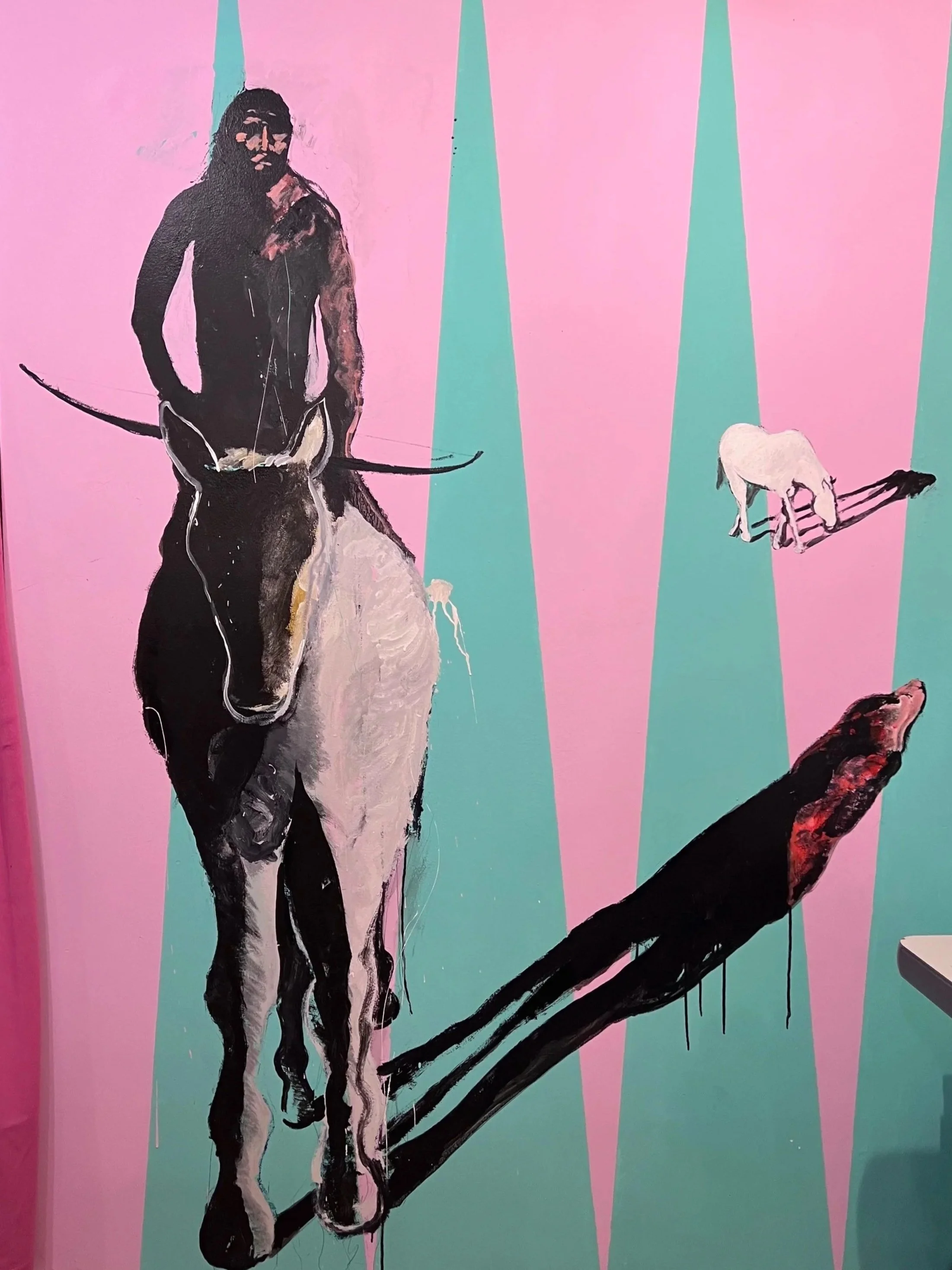 Colorful painting of a black-and-white magpie perched on a branch, with a small white mouse and another bird against a pink and turquoise striped background.