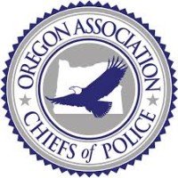 Logo of the Oregon Association of Chiefs of Police featuring a flying bird in the center.
