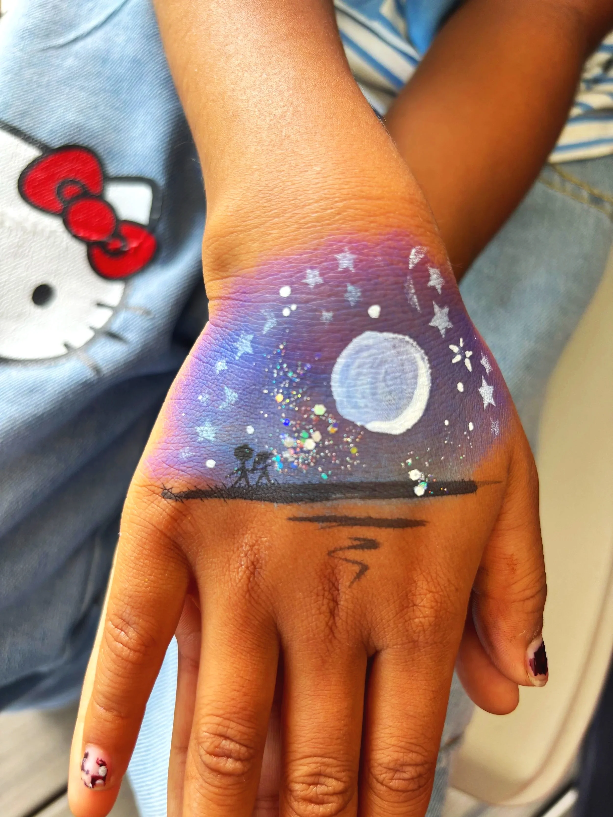 Close-up of a hand face paint of a galaxy