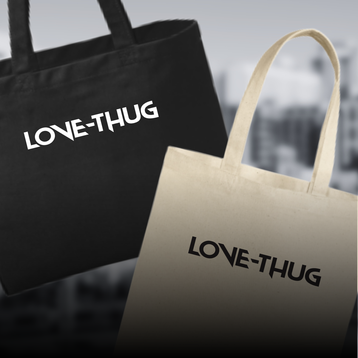 Black and cream-colored tote bags with the words "LOVE-THUG" printed on them, hanging against a blurred outdoor background.