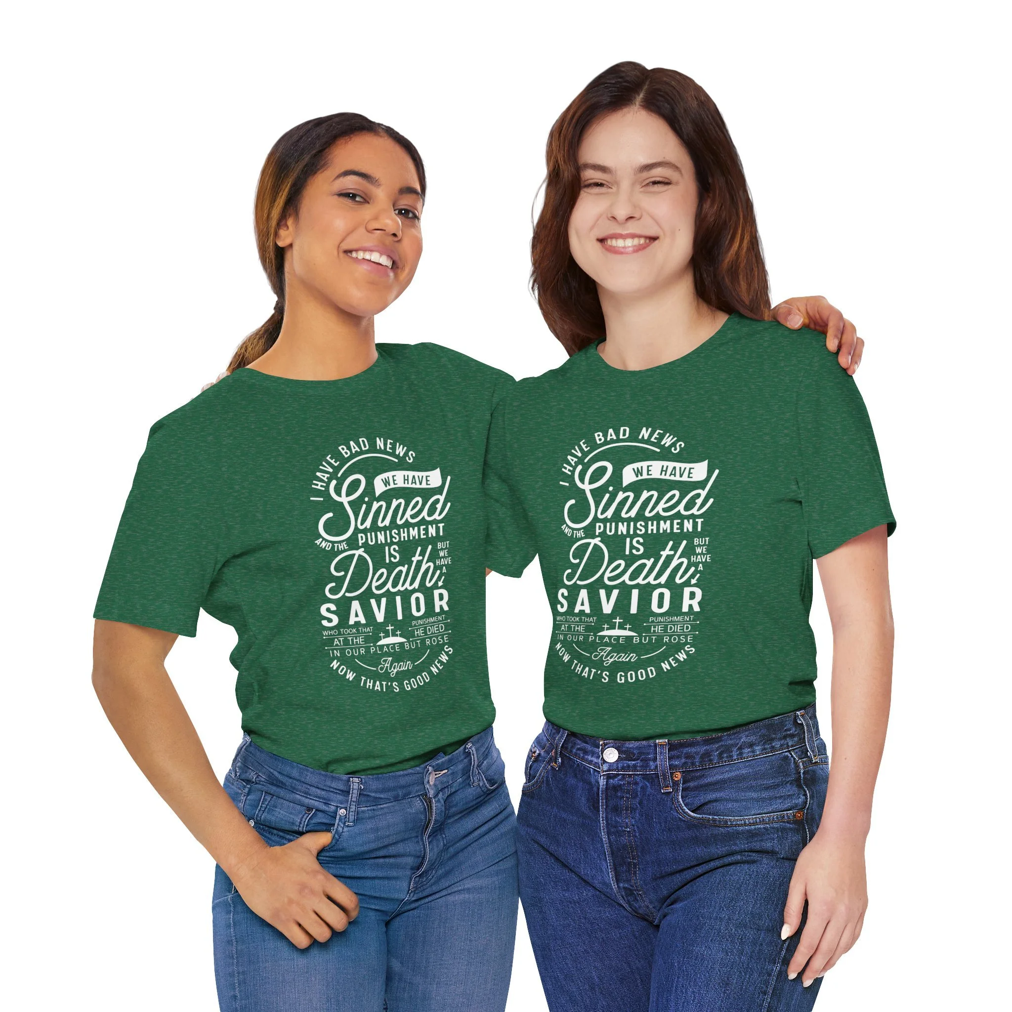 Two women standing close together wearing matching green t-shirts with white text, smiling, with one woman's hand on the other's shoulder, and one woman has her arm around the other's waist, against a plain white background.