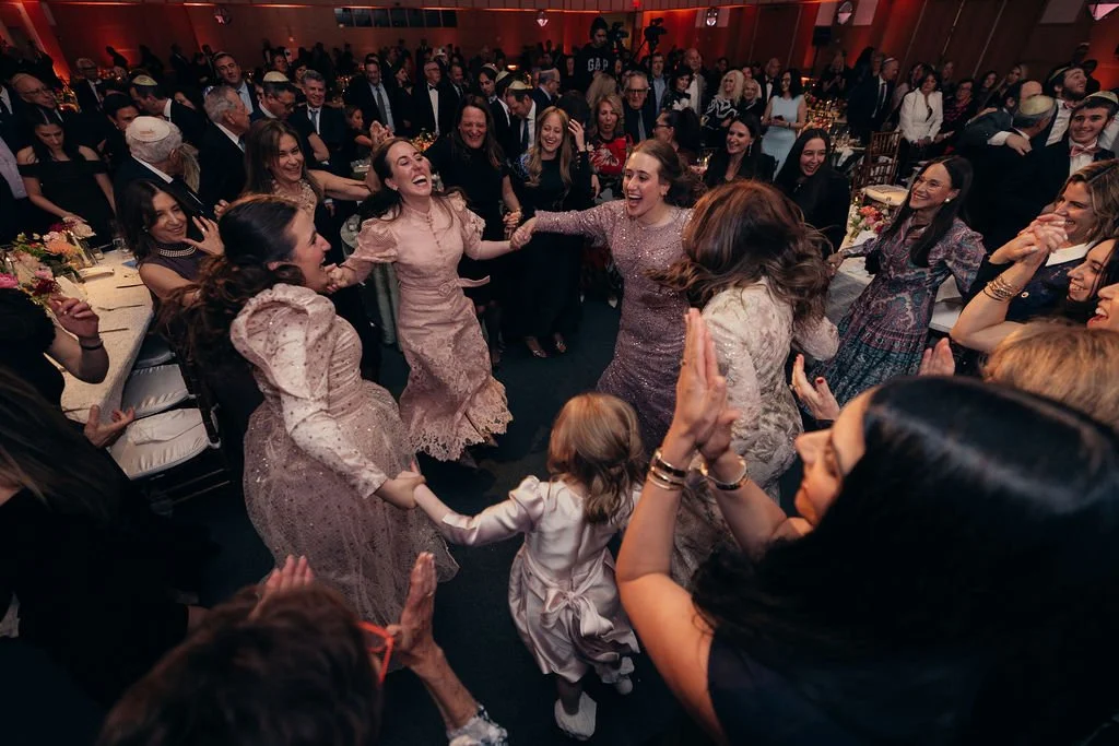 Guests dance in a circle in the crowded ballroom at the Chabad Chestnut Hill gala