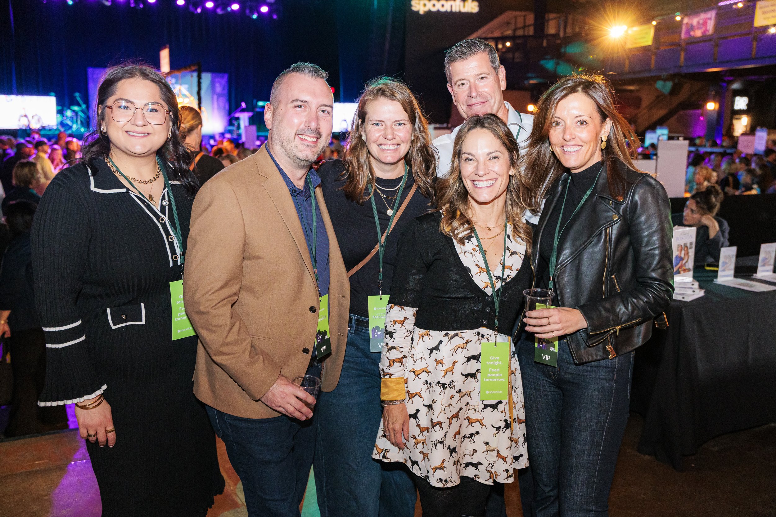 A group of guests poses together under the venue lights at the Spoonfuls gala