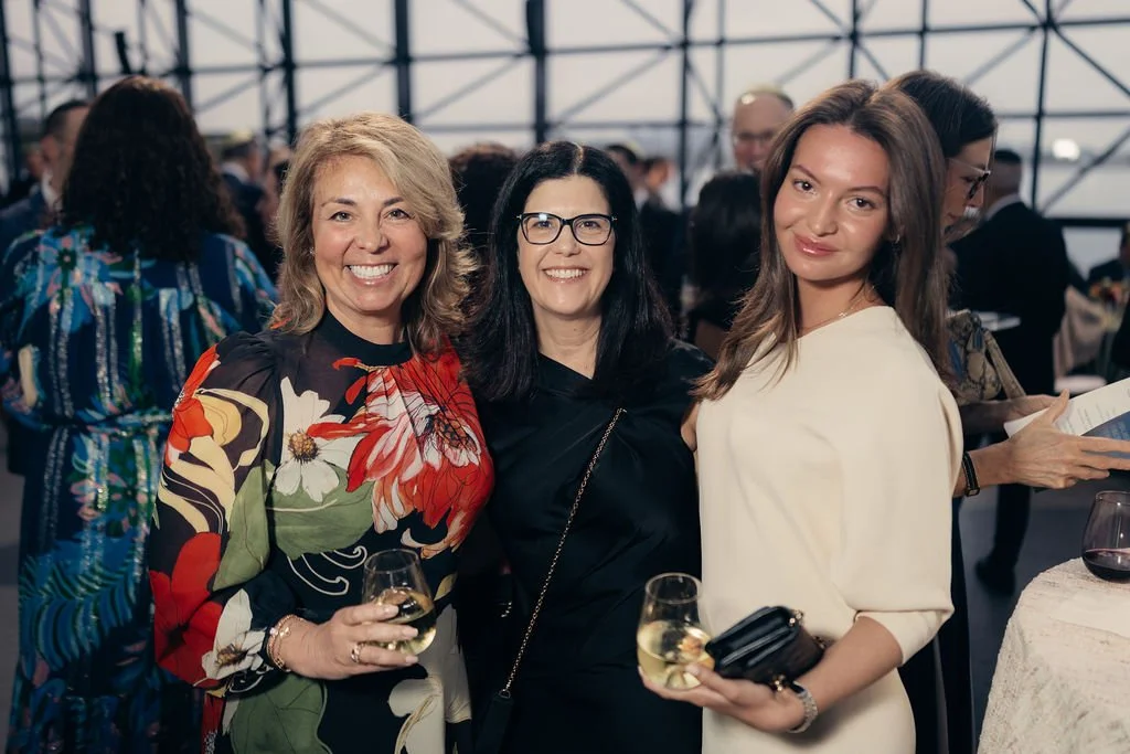 Three guests pose together during the cocktail reception at the Chabad Chestnut Hill gala