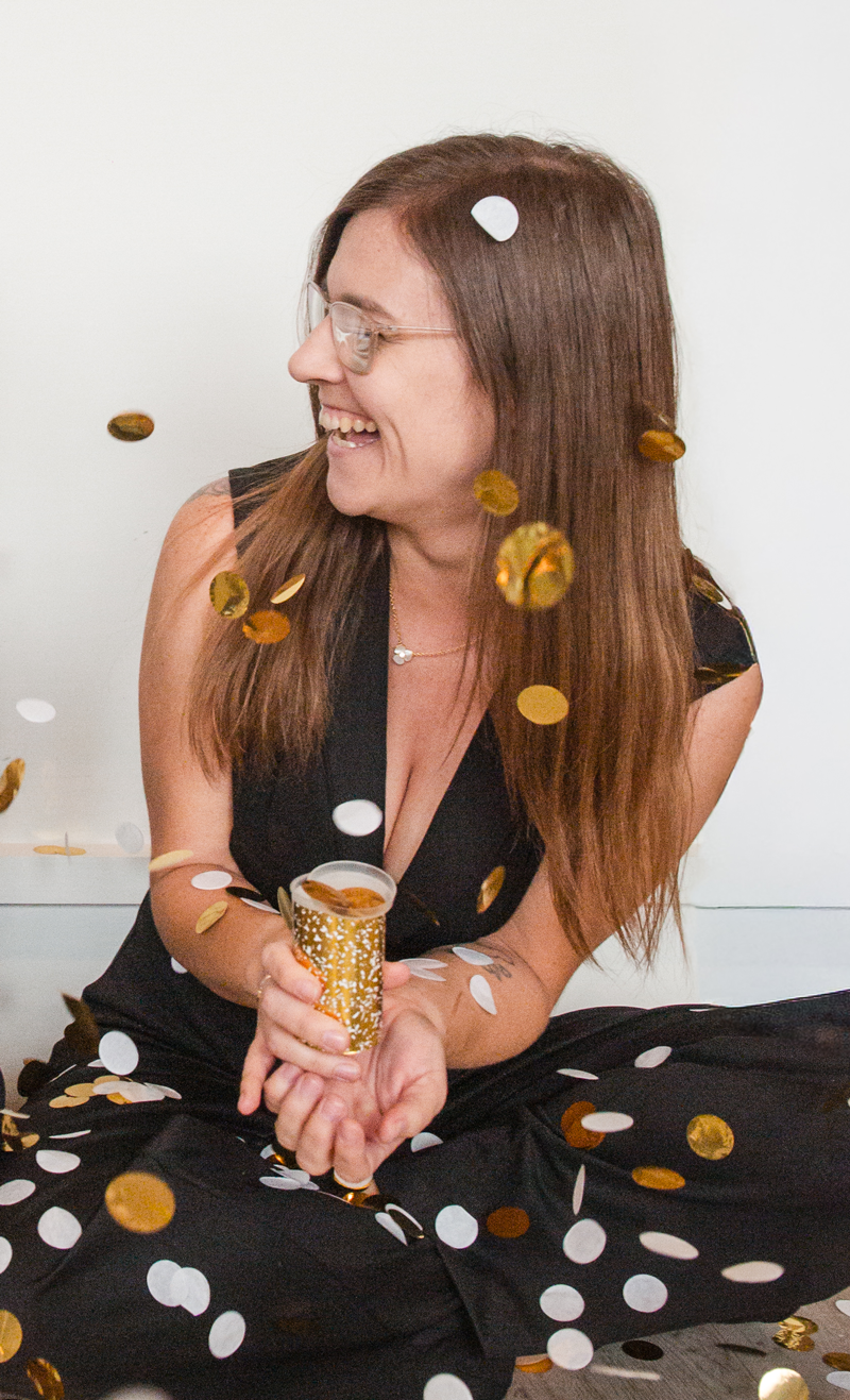 Mel Race, Vice President of Operations at ONE28, smiling surrounded by confetti