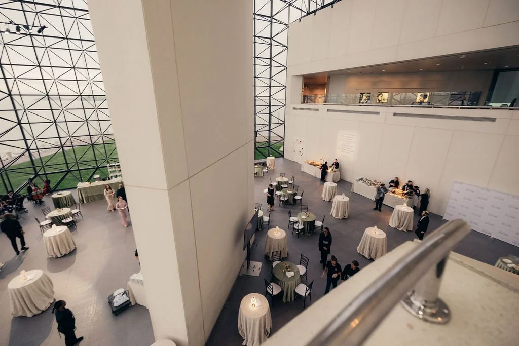 Overhead view of the glass atrium set with cocktail tables before guests arrive