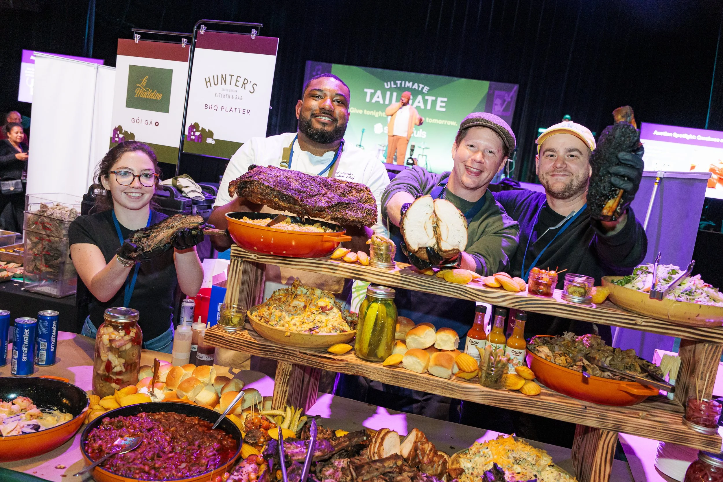 Chefs serve from an abundant tailgate food display at the Spoonfuls gala