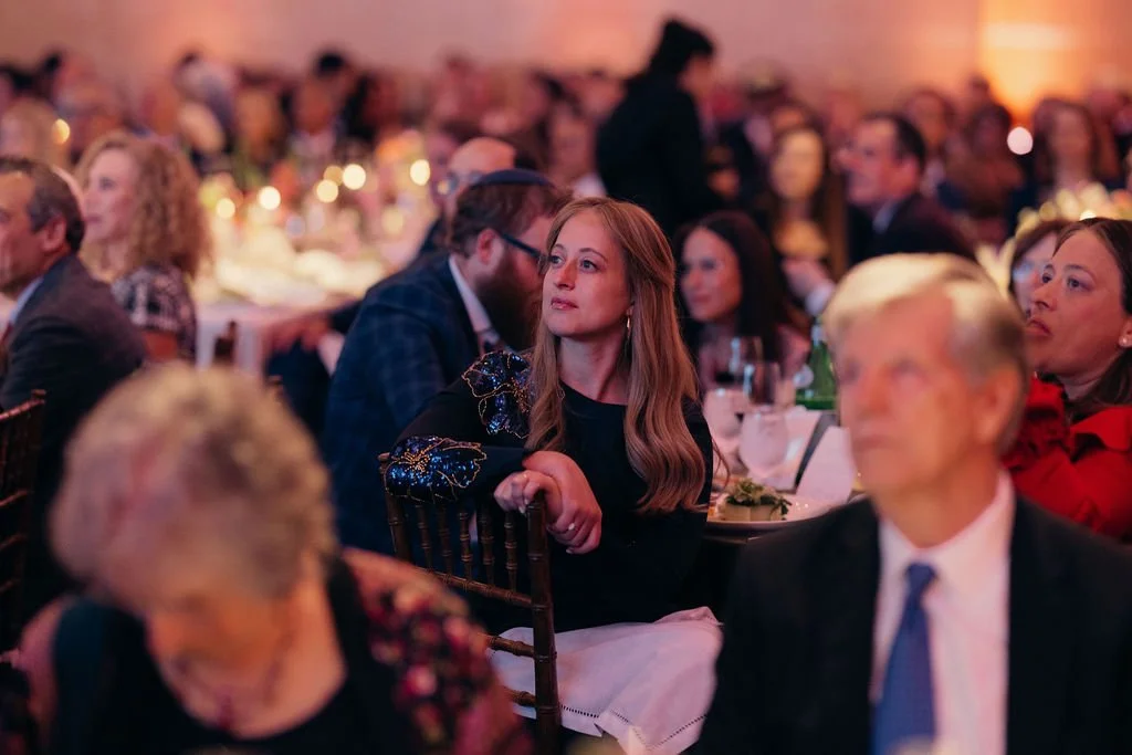 Guests at candlelit tables listen to the program at the Chabad Chestnut Hill 25th anniversary gala