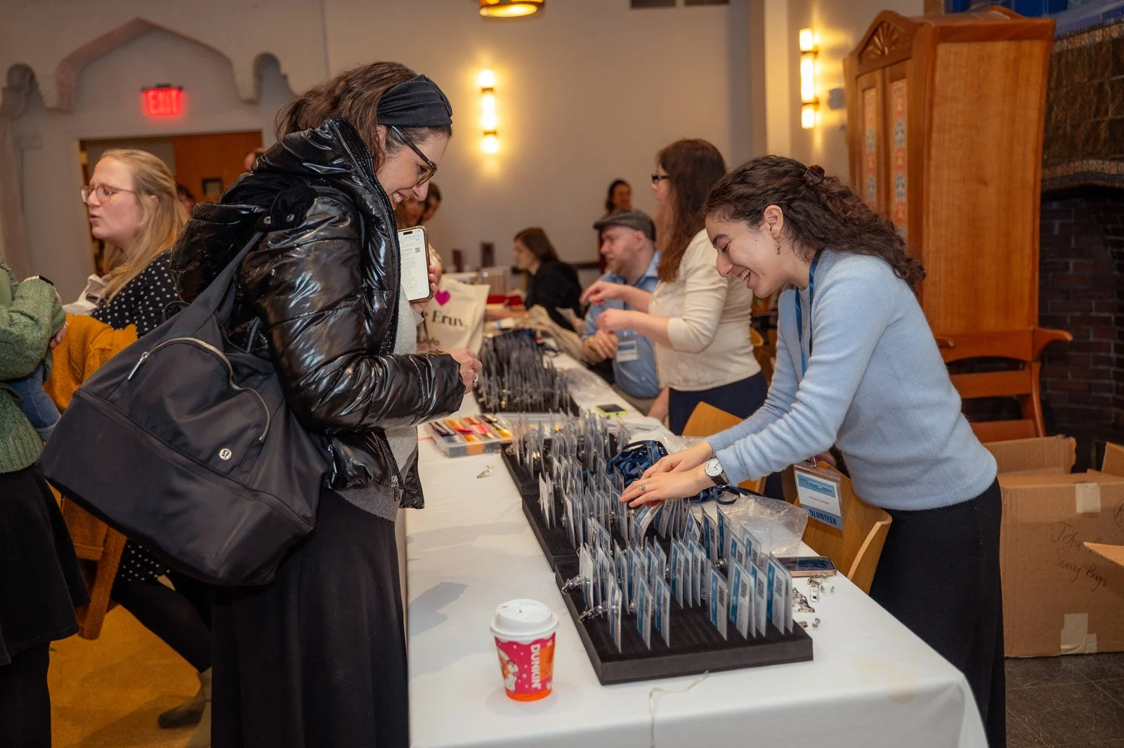 Attendees pick up name badges at the registration table at the JOFA International Conference
