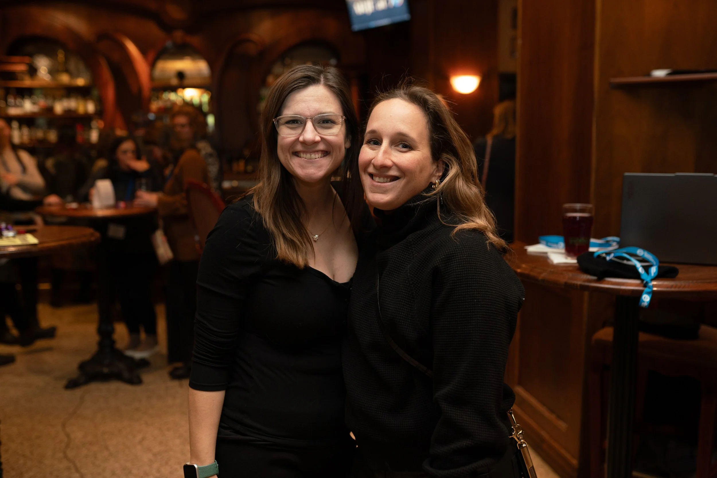 Two attendees pose together at an evening reception during the ARJE conference