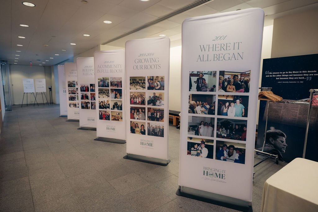 A row of photo banners celebrating the community's history lines the hallway at the gala