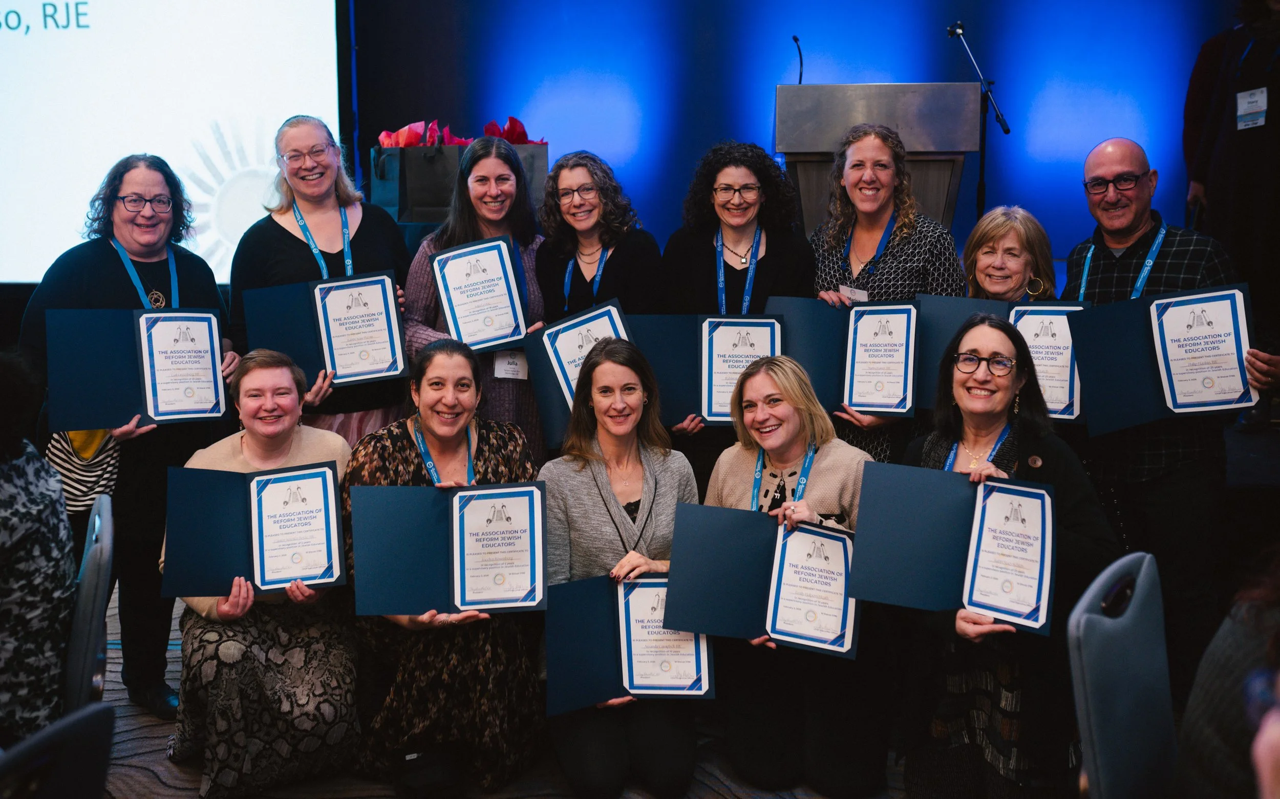 A group of educators holding certificates at the ARJE conference awards