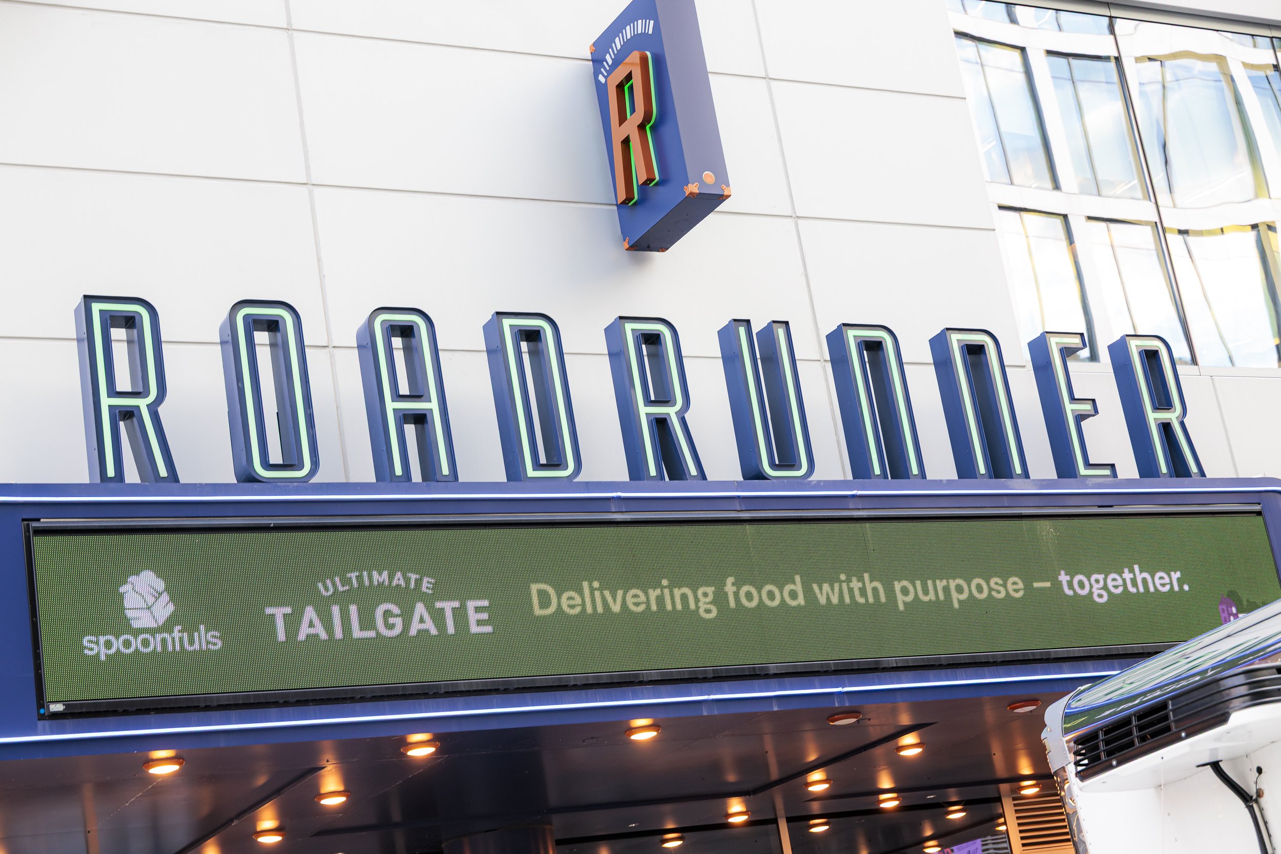 The Roadrunner marquee in Boston with a Spoonfuls Ultimate Tailgate banner reading Delivering food with purpose, together