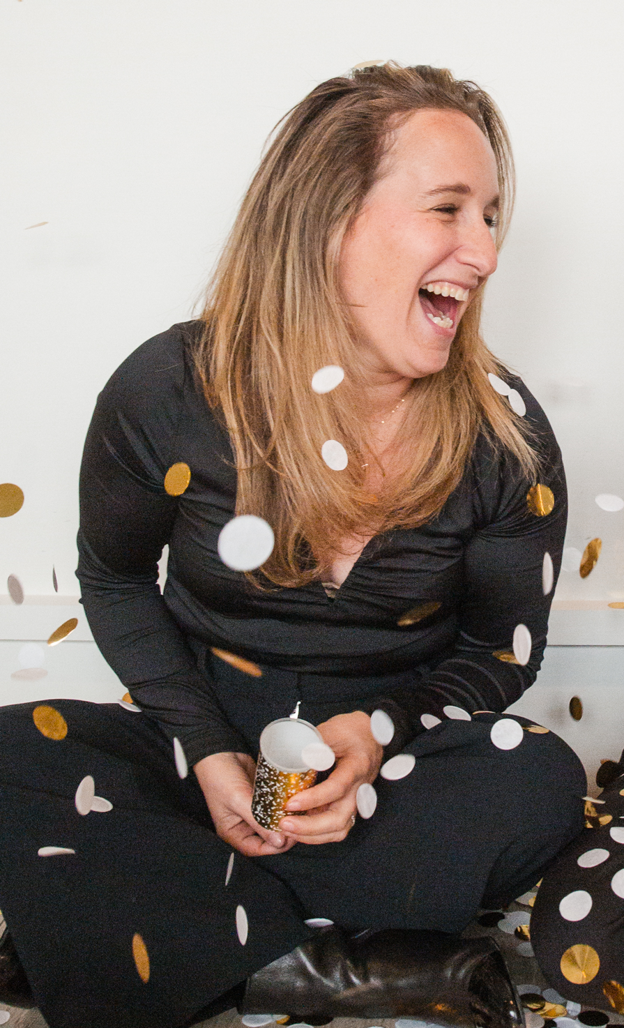 Leora Kimmel Greene, Founder and President of ONE28, laughing while surrounded by confetti