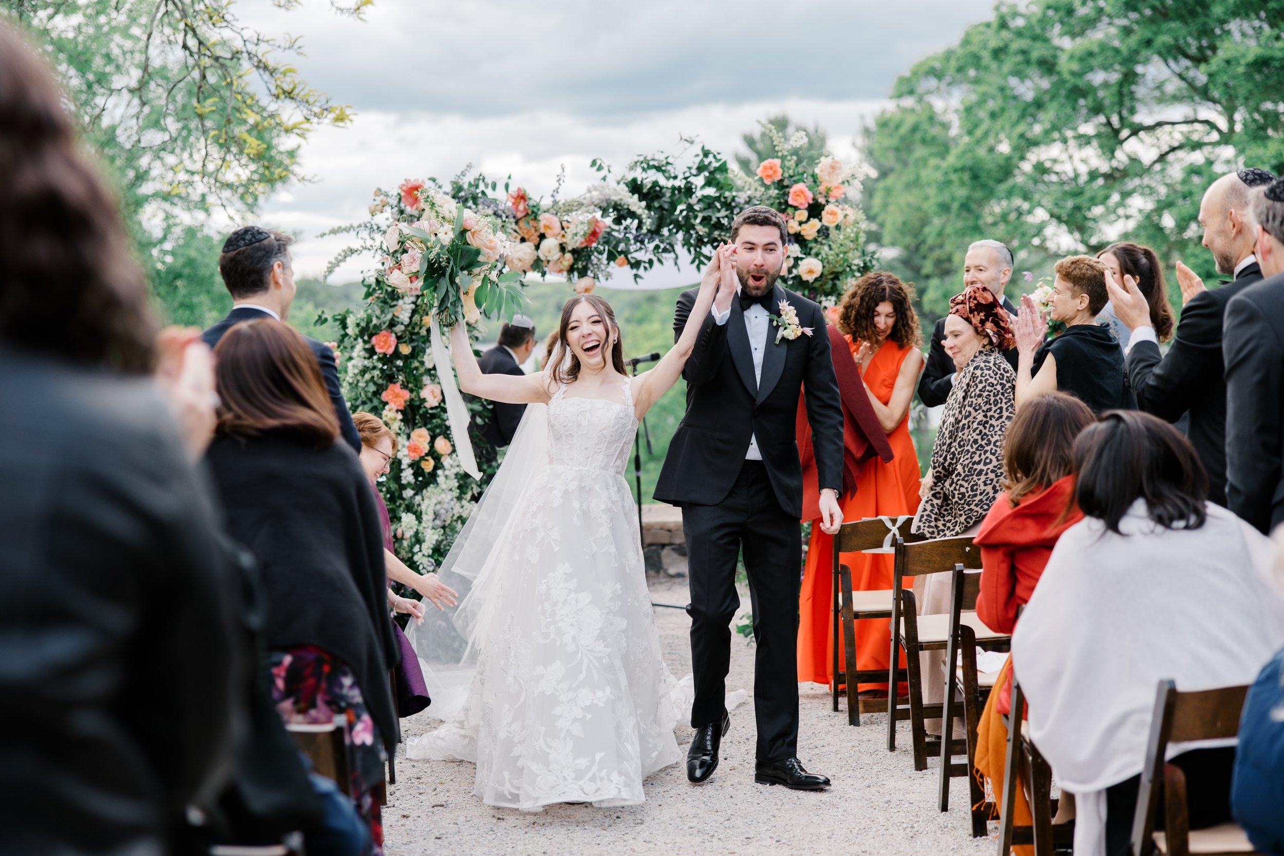 The newlyweds celebrate as they walk back up the aisle past cheering guests