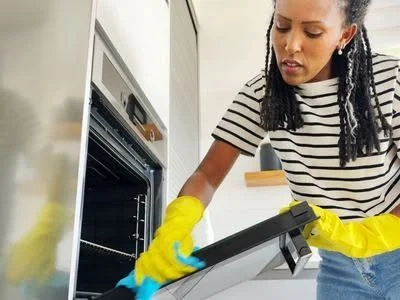 Order & Grace team member cleaning an oven in a Toledo, Ohio home