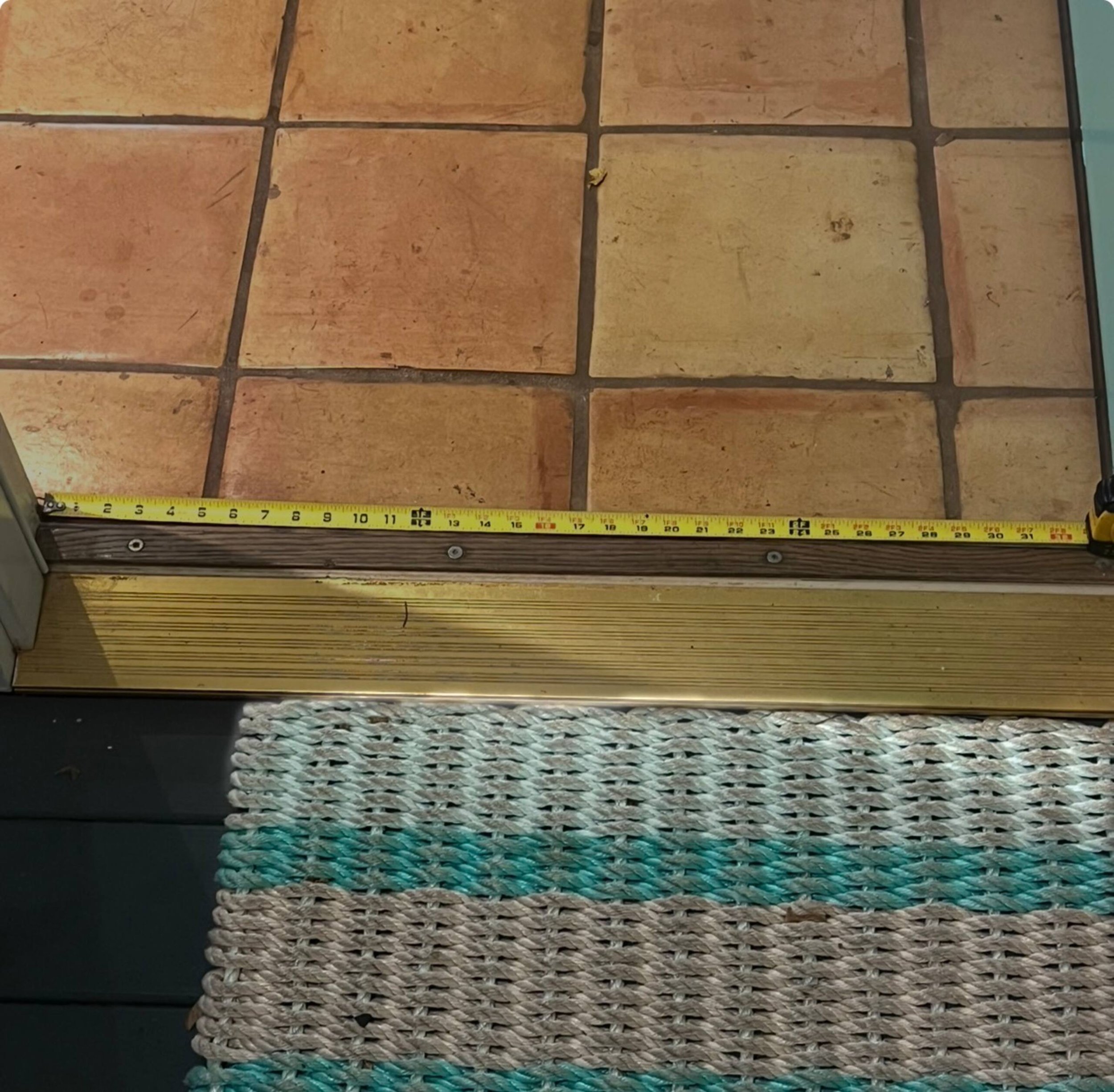 A variety of woven baskets in different colors and textures stacked vertically, with a measuring tape at the top indicating their height.
