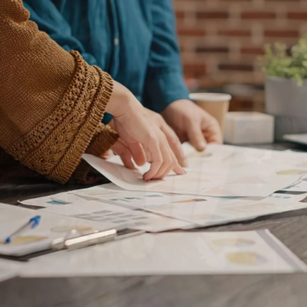 hands belonging to two people discussing paperwork
