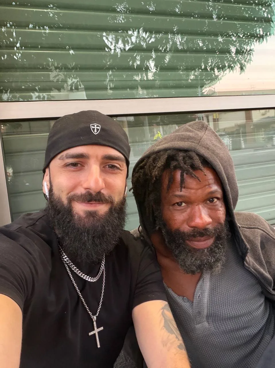 Founder of In the Name of Jesus Foundation smiling alongside a man experiencing homelessness who has received assistance on numerous occasions through the generosity of the Foundation's supporters.