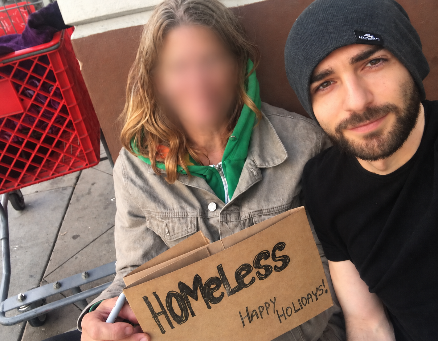 Felix Ryan, Founder and President of In the Name of Jesus Foundation, sitting with a neighbor during community outreach.