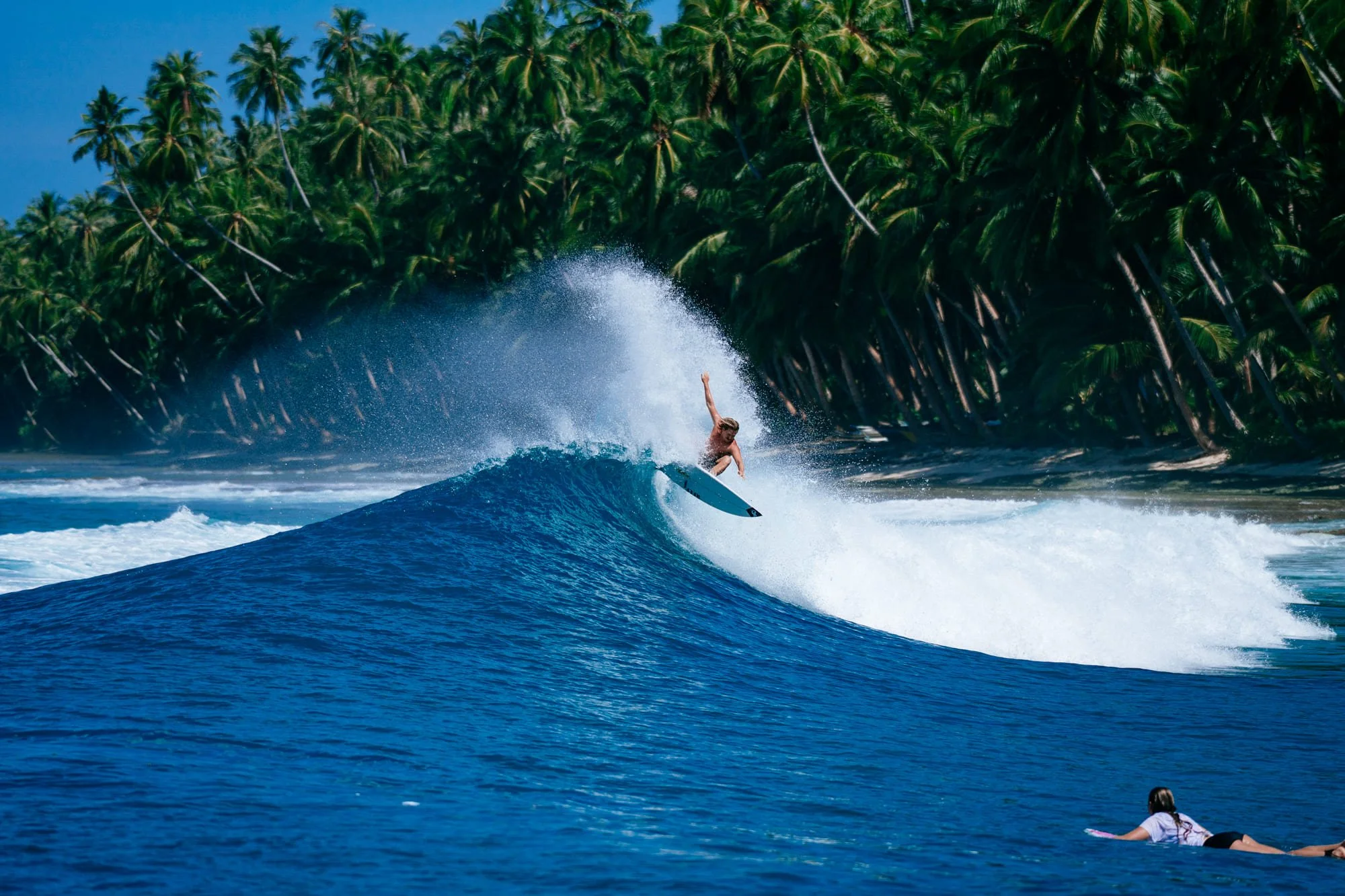 Spray of a surfer sending it during a surf session in the Telos