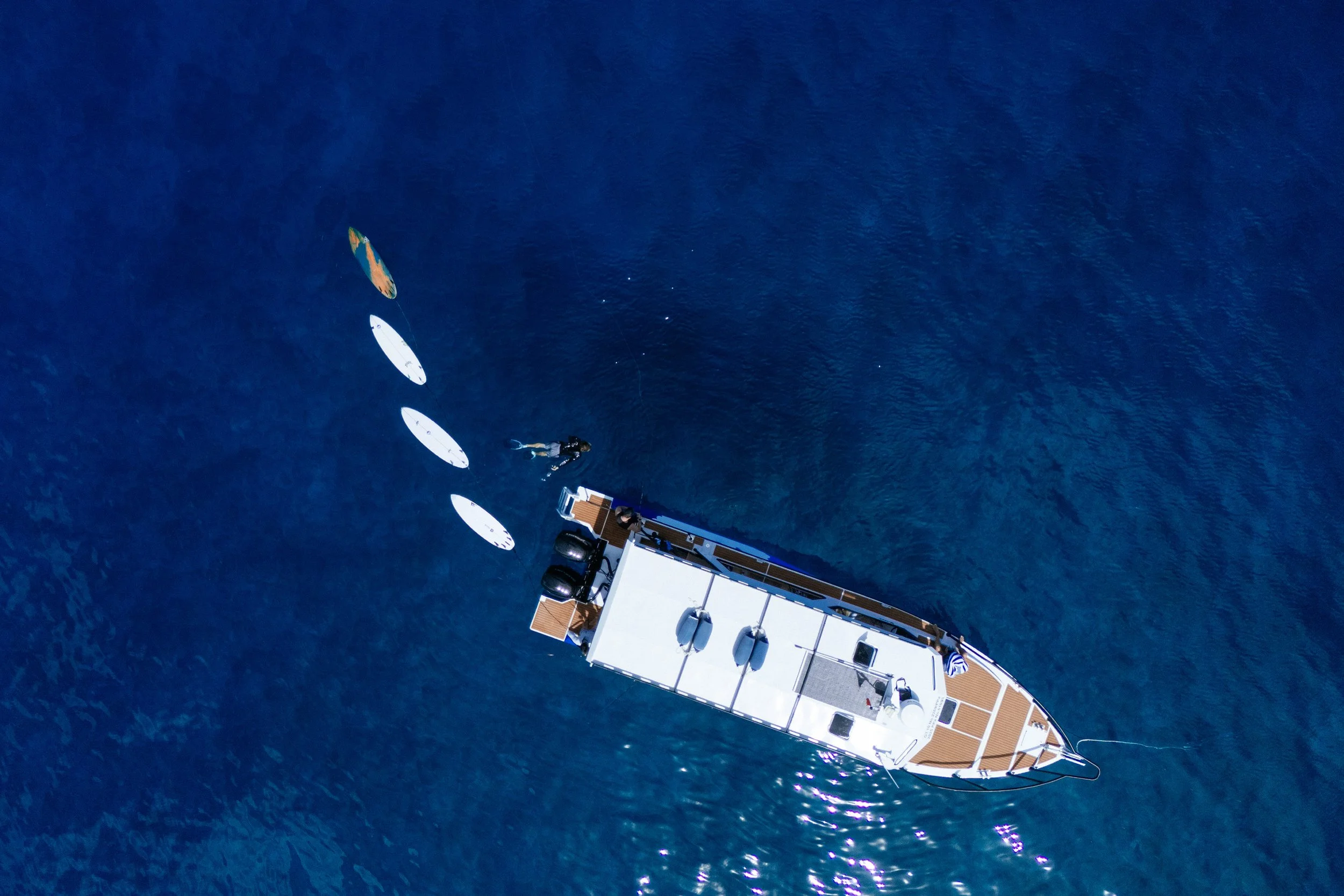 Surfboards stacked aboard one of Tanah Mympi's boats, seen from above.