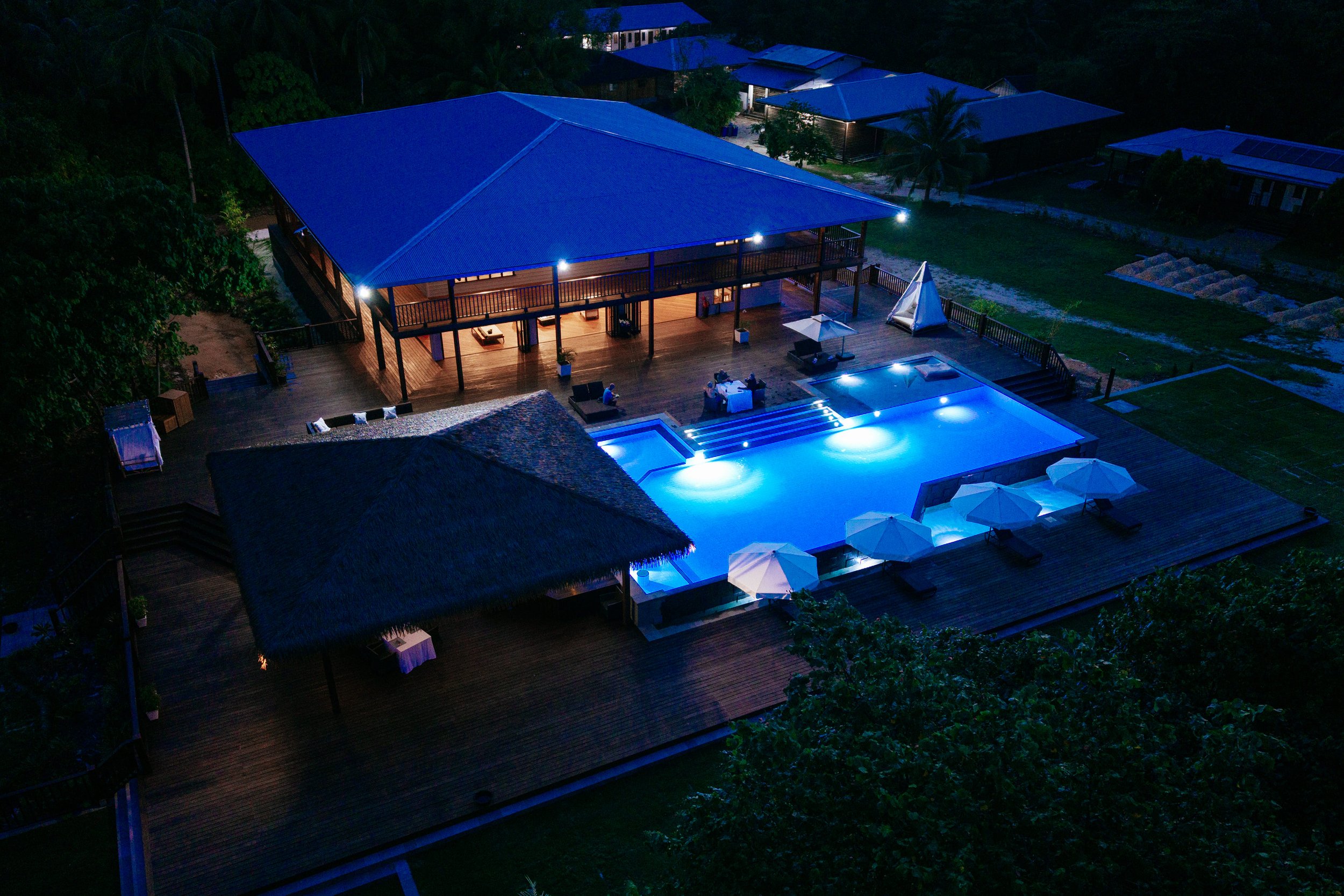 Aerial shot of the Island's pavillion and pool at night