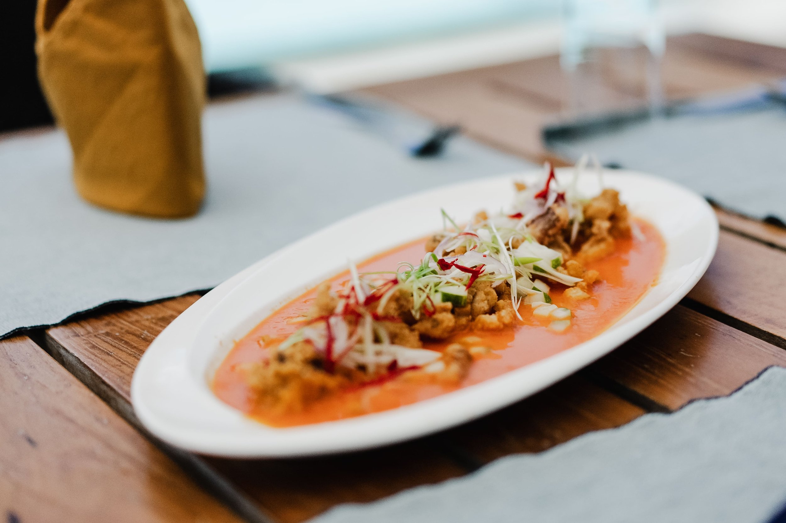 A plated dish from Tanah Mympi's kitchen, presented for dinner service.