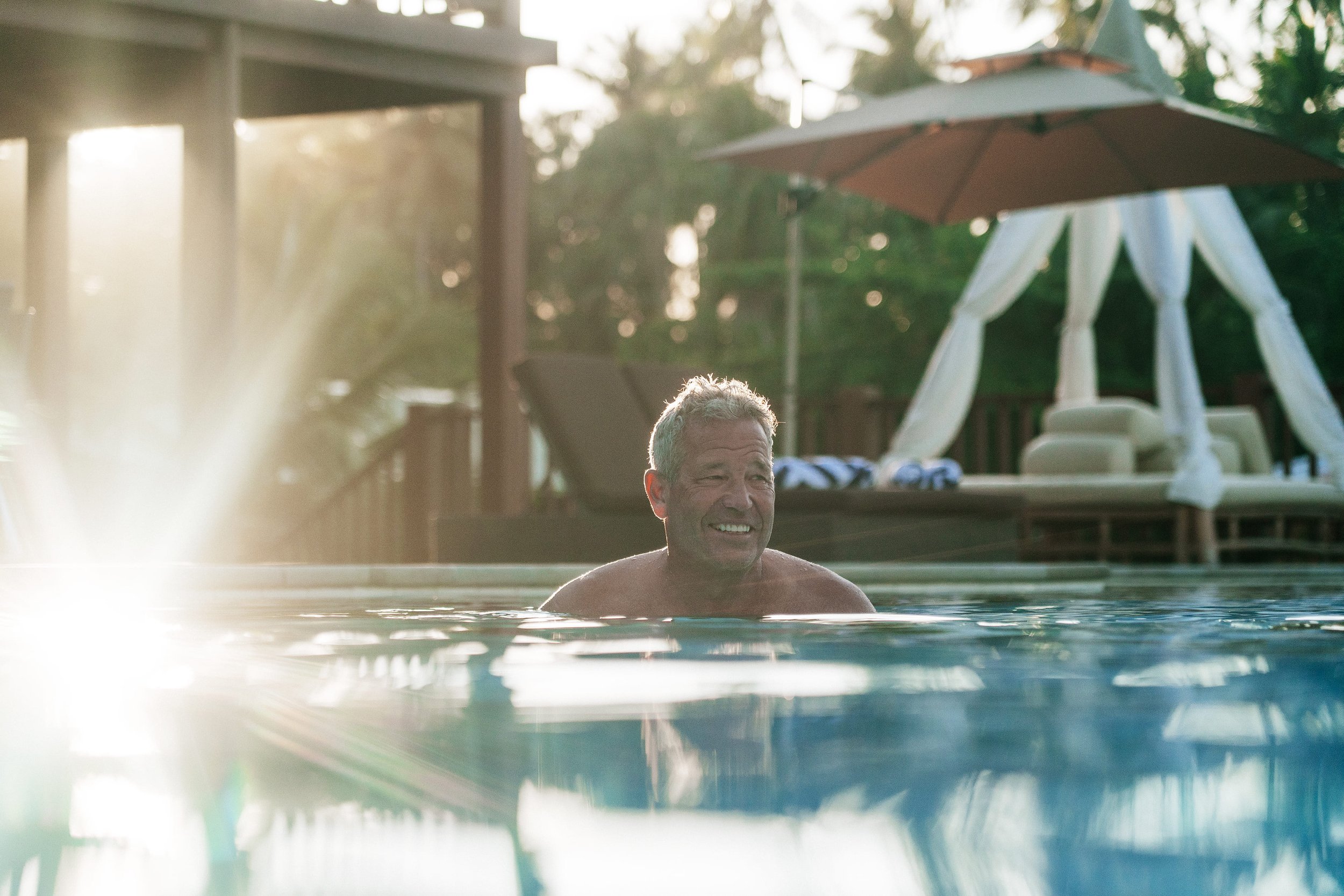 Guest enjoying at the swim-up bar in Tanah Mympi's pool.