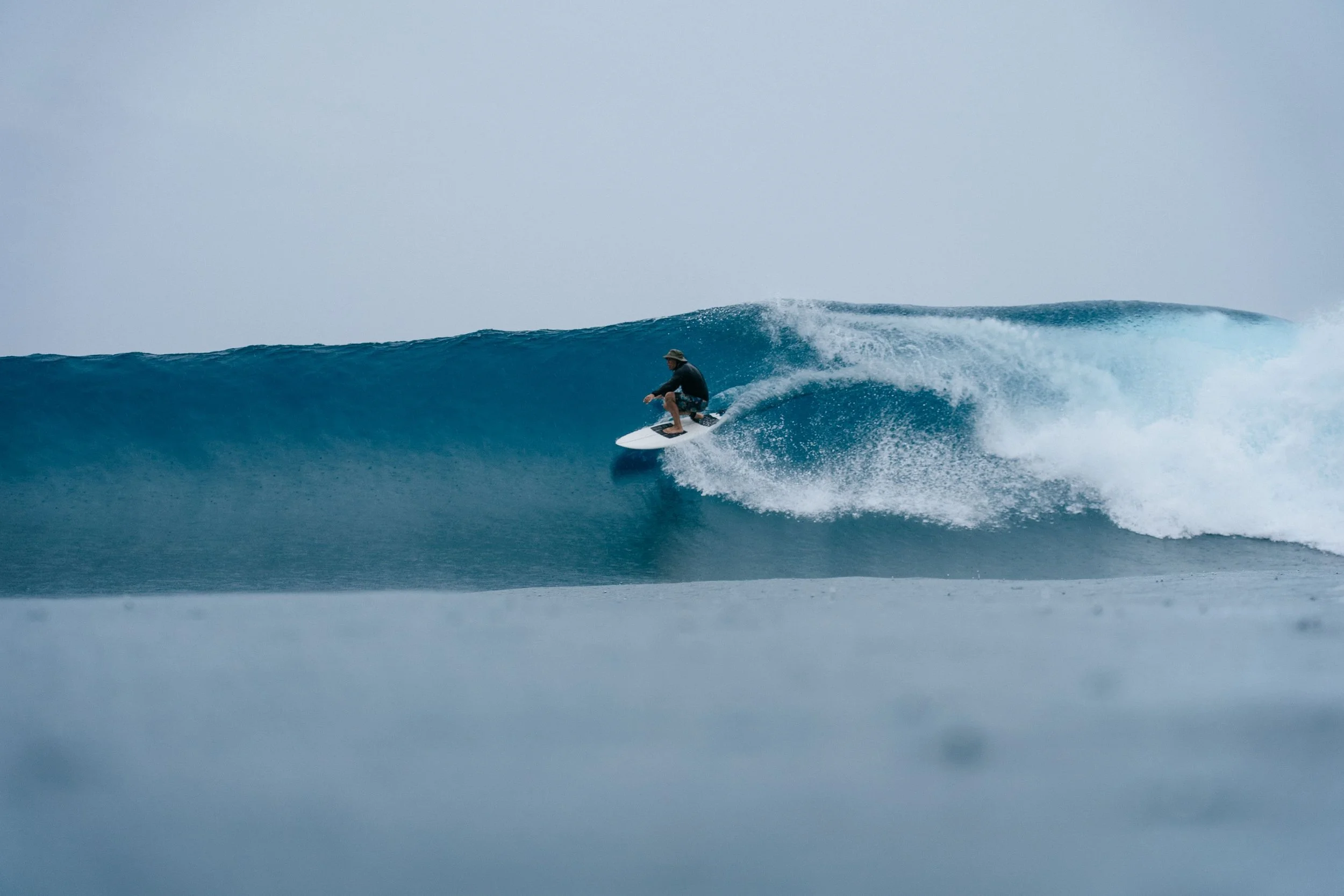 surfer gliding through an empty wave during the secret surf season.