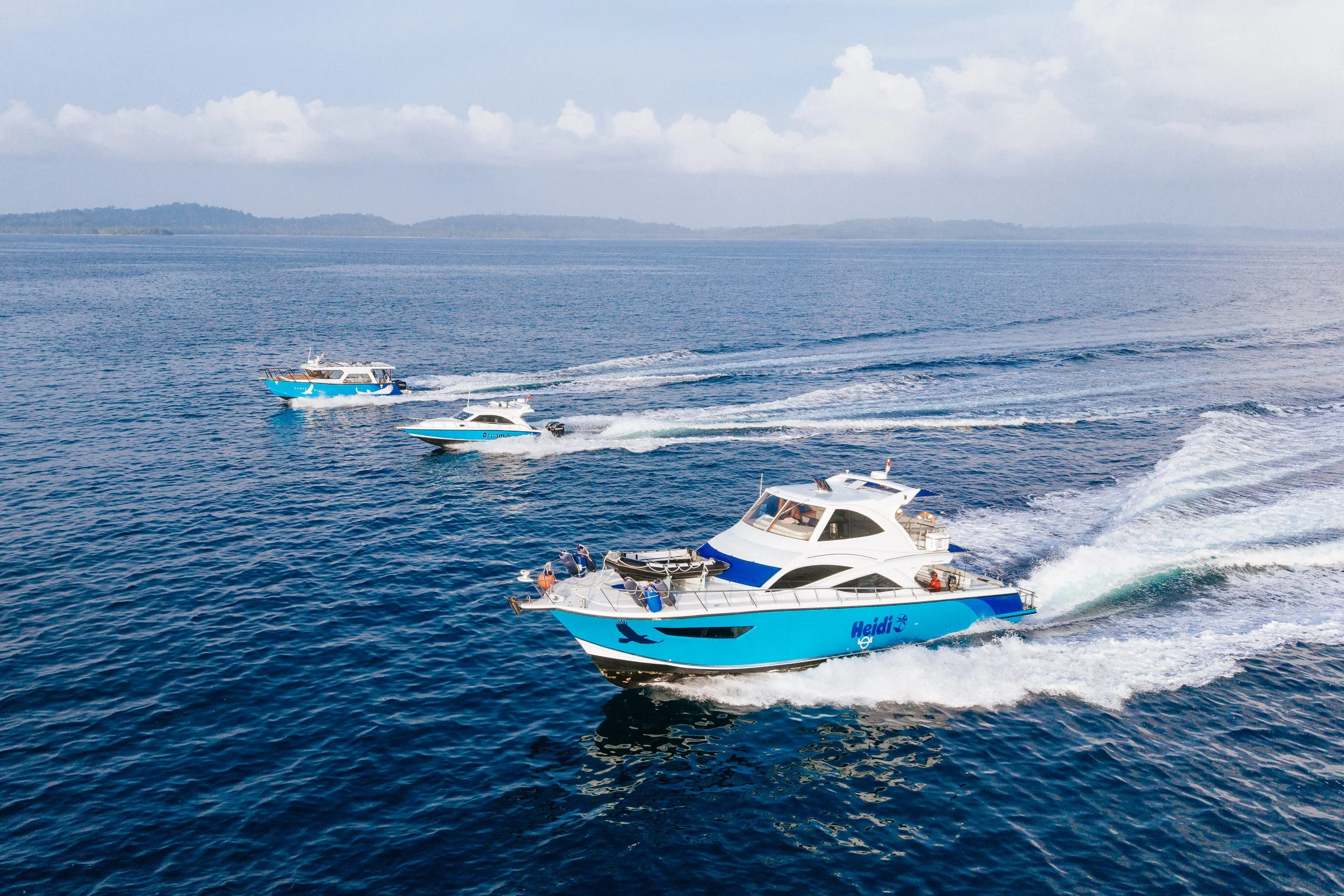 Tanah Mympi's fleet of speedboats lined up, ready to run guests out to the surf.