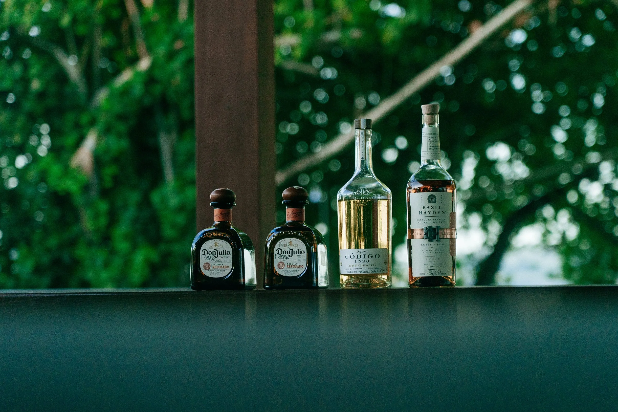 A row of spirits lines the bar at Tanah Mympi, ready for the resort's cocktail menu.